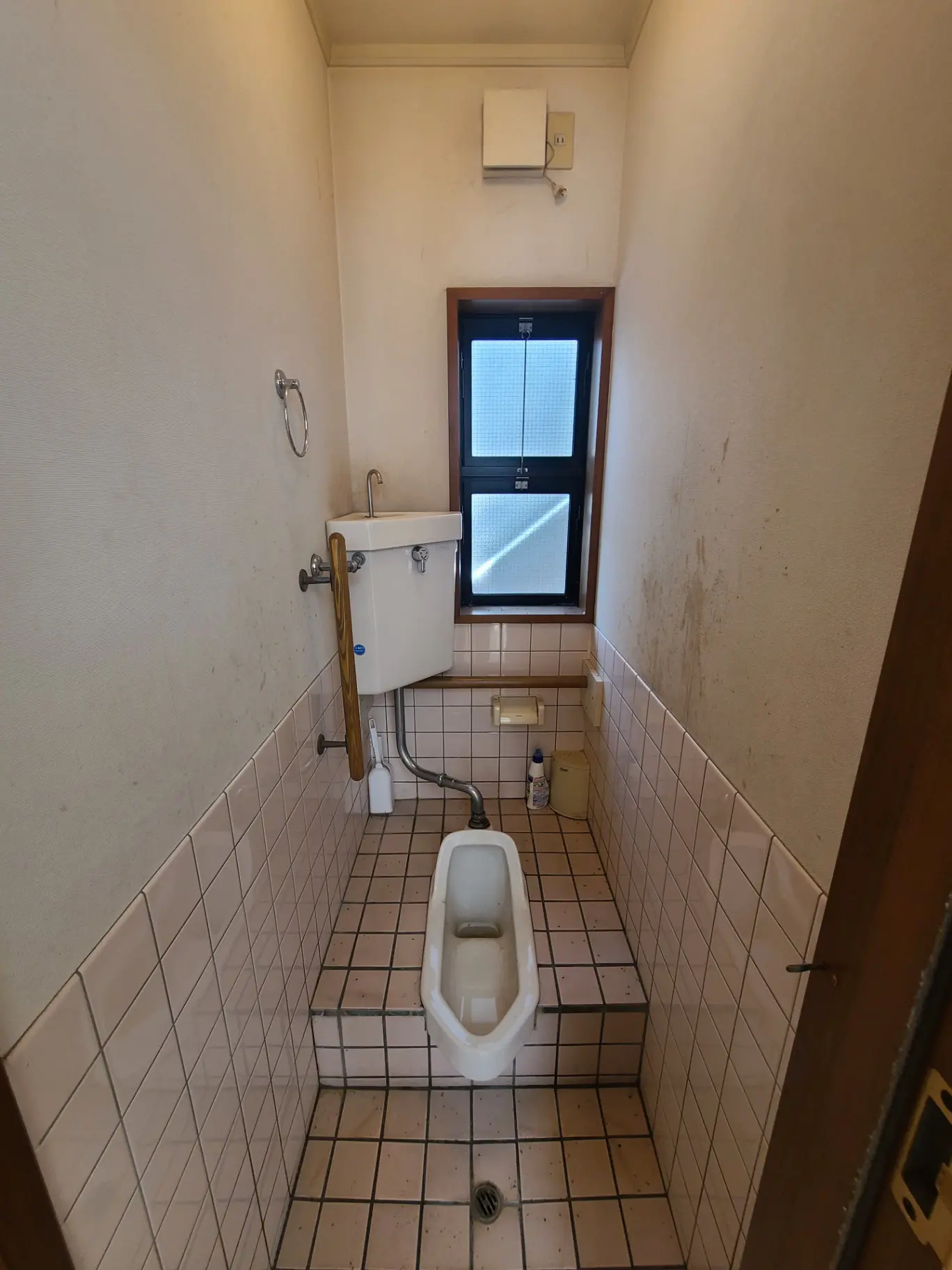 和式トイレが備えられたシンプルなバスルーム