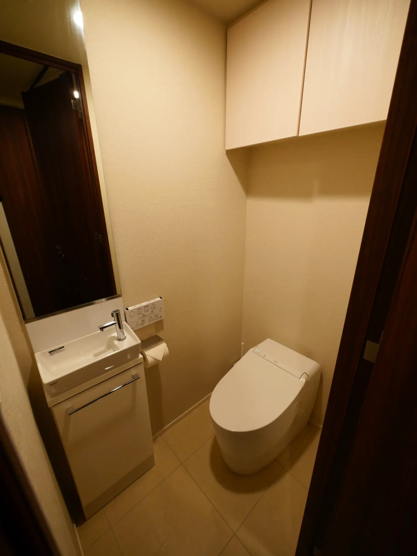 コンパクトなデザインのトイレと手洗いカウンター、暖かい照明と洗練されたインテリア