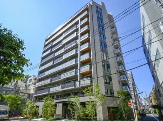 都市部のモダンなマンション外観、多階層建築、晴れた日の青空と周囲のビル