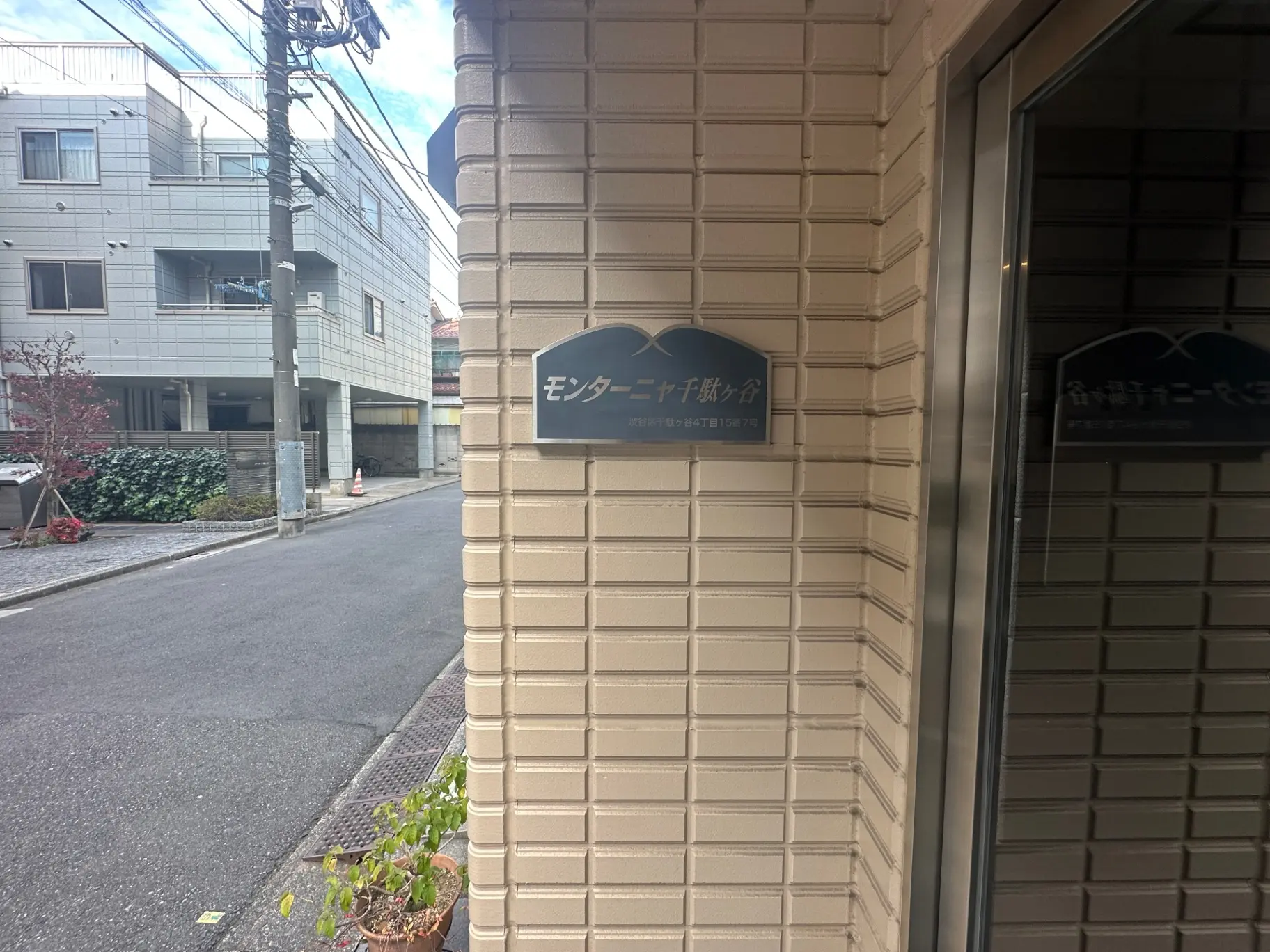 建物の壁に取り付けられた看板、周囲に建物と歩道が見える都市の景観