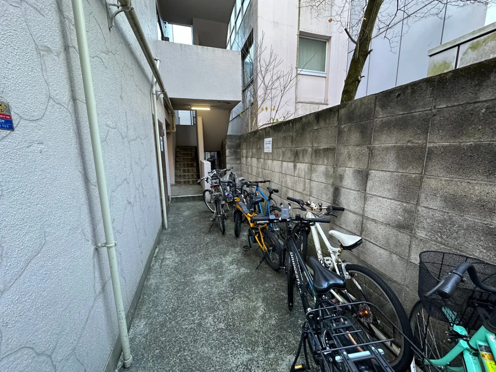 都市のアパートメント複合施設の自転車駐輪場、コンクリートの壁と建物の入り口