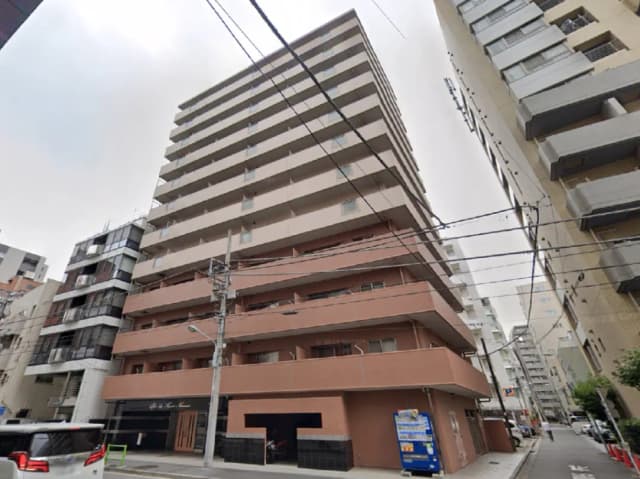 - 都市的な雰囲気の中にある8階建ての住宅ビル、近隣の建物と電線が交差する景観