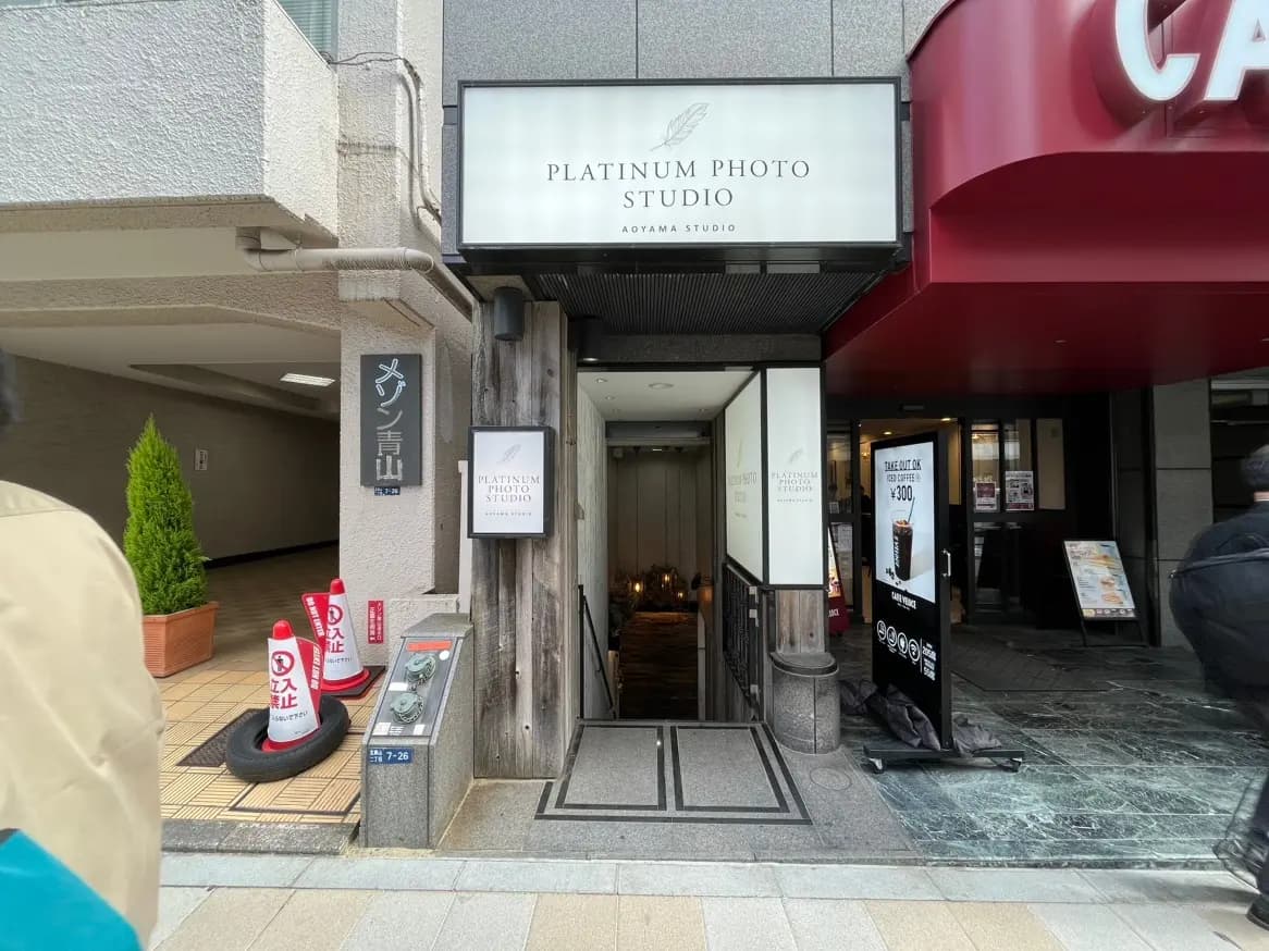 街中にあるプラチナフォトスタジオの入り口、看板と案内表示がある外観