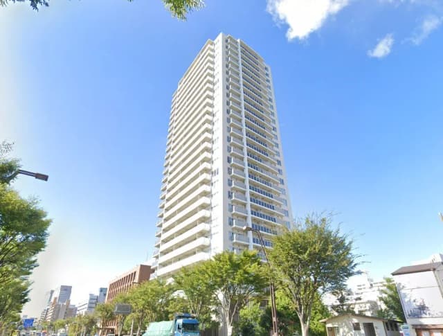 晴れた日の高層マンション、都市の風景と緑の木々