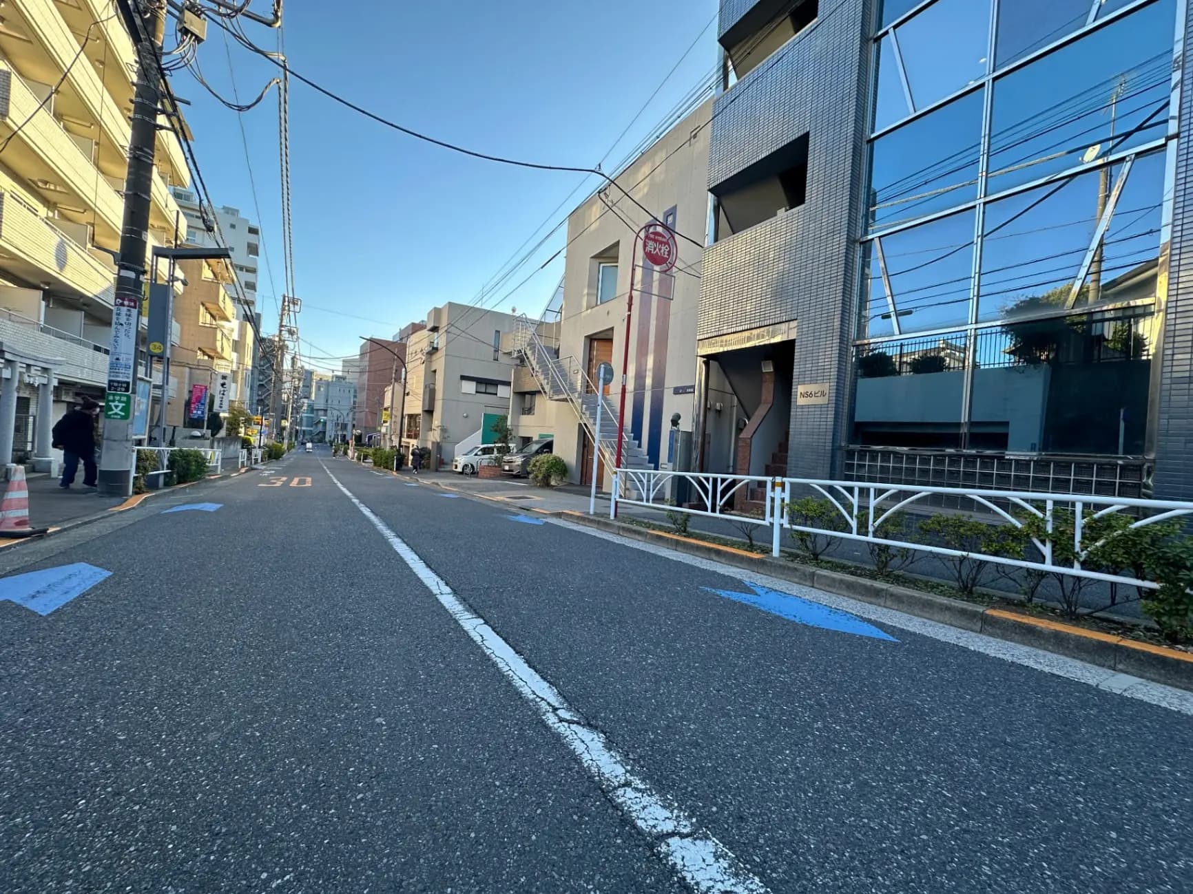 日本の都市の静かな通り、建物の側面には大きなガラス窓、清潔で整然とした街並み