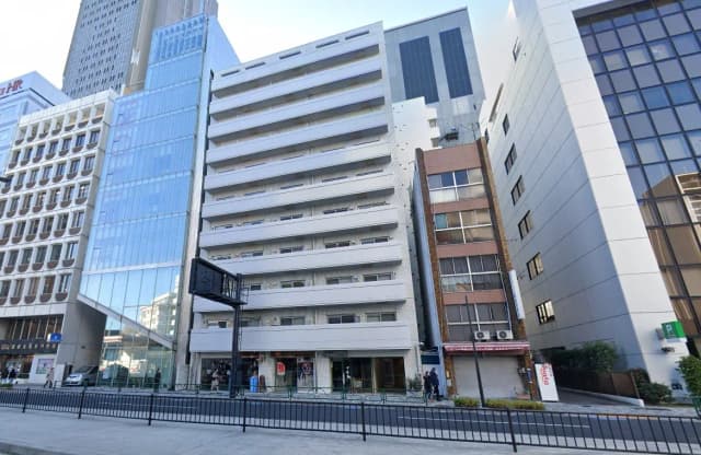 - 近代的なオフィスビルと複数の商業施設が並ぶ街並み、ガラス張りの外観と白い外壁の建物が特徴
