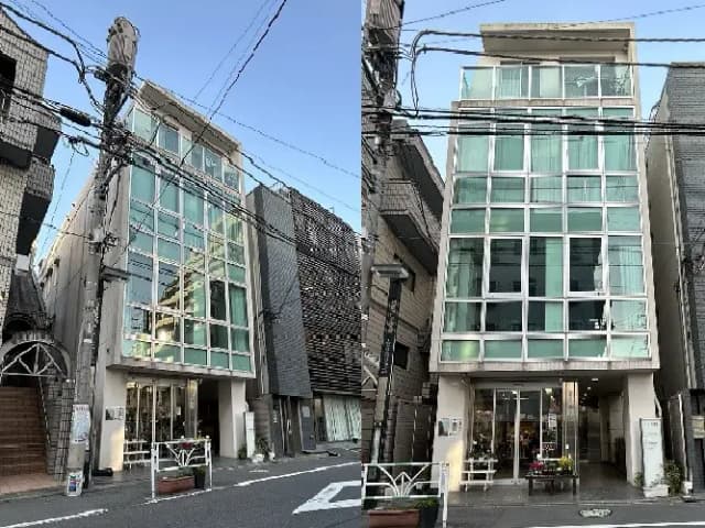 - 近代的なガラス張りの建物の外観、周囲には他の商業ビルが立ち並び、道路に面している様子