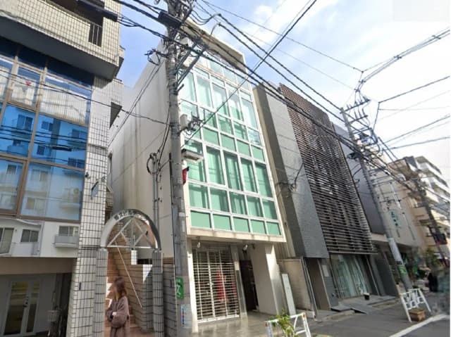- 近代的なデザインのビルの外観、ガラス張りのファサードと隣接する建物が並ぶ都市の景観