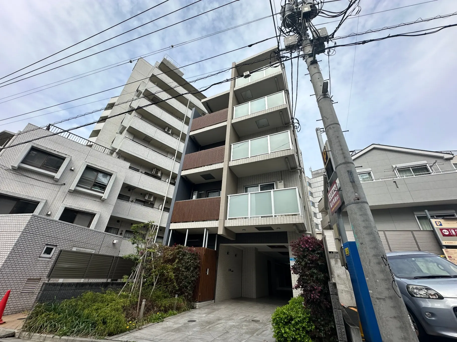 都会のマンション外観、近代的なデザイン、バルコニーと駐車場付き