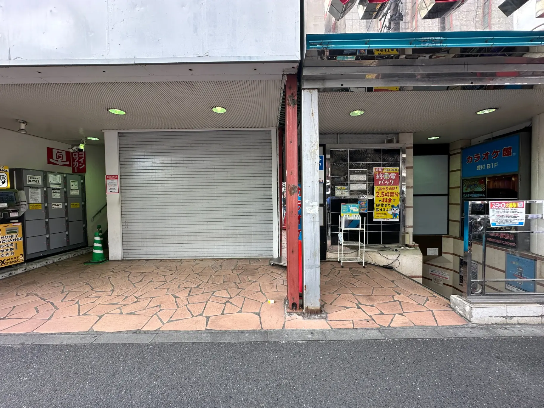閉店したシャッター付きの店舗と営業中の店舗の並び、都市の商店街の風景