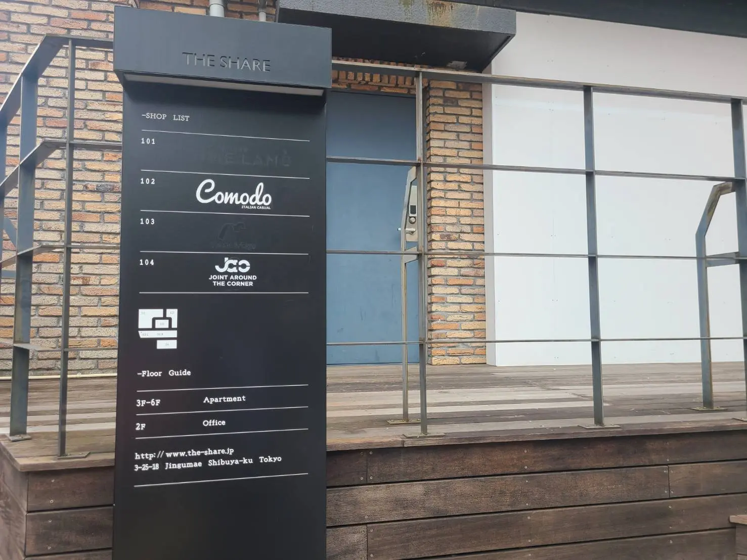 ショップリストを示す案内板とブリックの壁があるビルのエントランス, 東京都渋谷区