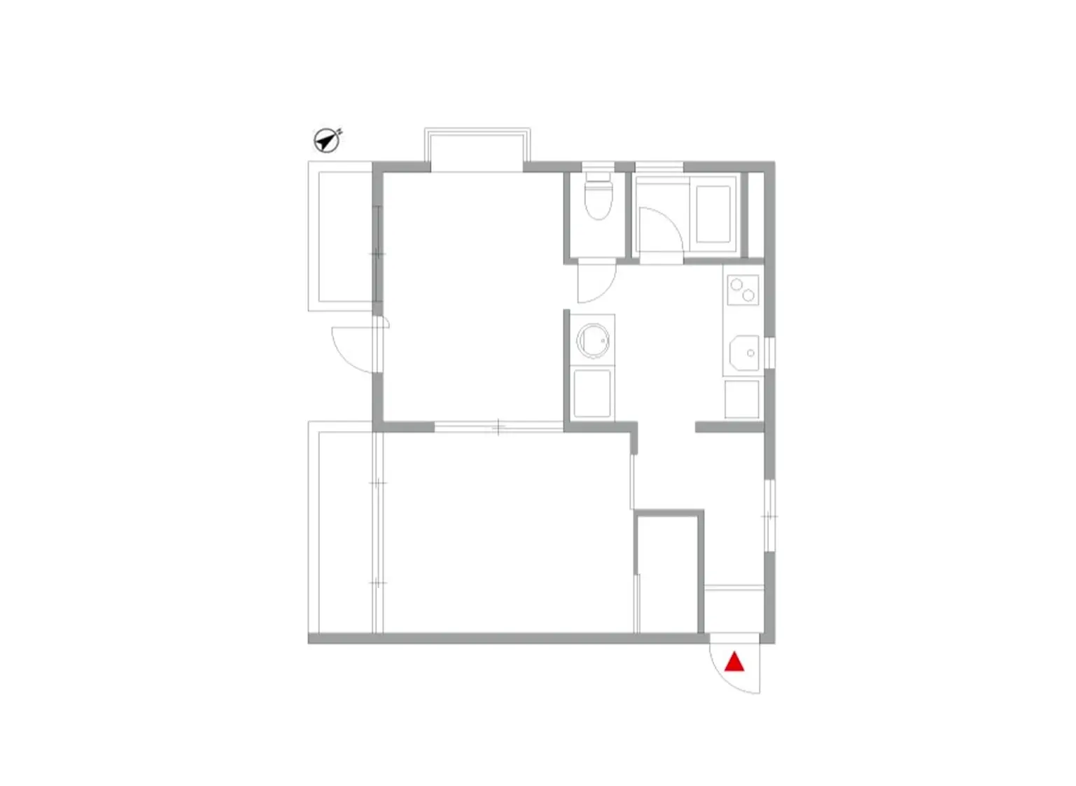 - 広いリビングルームとキッチンがつながる間取り図、浴室とトイレを備えたシンプルなレイアウト、赤い矢印が示す玄関口